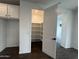 Bright, open pantry with ample shelving and dark wood floors enhances storage convenience at 6947 W Spur Dr, Peoria, AZ 85383