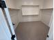 Walk-in closet features wood shelving and neutral carpeting at 6947 W Spur Dr, Peoria, AZ 85383