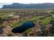 Scenic aerial shot of a golf course community with a beautiful pond surrounded by lush greenery at 7710 E Golden Eagle Cir, Gold Canyon, AZ 85118