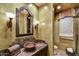 Charming powder room featuring a unique vessel sink, decorative lighting, and stylish fixtures at 7710 E Golden Eagle Cir, Gold Canyon, AZ 85118
