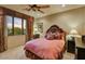 Inviting bedroom with a plush bed, a ceiling fan, and scenic views, creating a relaxing retreat at 7710 E Golden Eagle Cir, Gold Canyon, AZ 85118