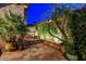 Tranquil courtyard at night with palm trees, a tiered fountain, and soft lighting at 7710 E Golden Eagle Cir, Gold Canyon, AZ 85118