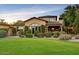 Charming home with a well-manicured lawn, mature landscaping, and a covered entryway at 7710 E Golden Eagle Cir, Gold Canyon, AZ 85118