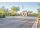 Stone gatehouse guarding a gated community with mature trees and an American flag at 7710 E Golden Eagle Cir, Gold Canyon, AZ 85118