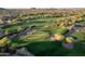 Aerial view of golf course featuring lush green fairways, sand traps, and scenic desert landscape at 7710 E Golden Eagle Cir, Gold Canyon, AZ 85118