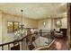 Elegant staircase with a chandelier, wood floors, and picturesque windows, adding architectural flair at 7710 E Golden Eagle Cir, Gold Canyon, AZ 85118