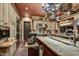 Gourmet kitchen featuring a large island, granite countertops, stainless steel appliances, and tile flooring at 7710 E Golden Eagle Cir, Gold Canyon, AZ 85118