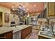 Well-appointed kitchen featuring stone tile flooring, granite countertops, stainless steel appliances, and custom cabinets at 7710 E Golden Eagle Cir, Gold Canyon, AZ 85118