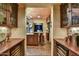 Kitchen features an island with seating, stainless steel appliances, custom cabinets, and built-in wine refrigerators at 7710 E Golden Eagle Cir, Gold Canyon, AZ 85118