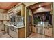 View of the kitchen leading to an outdoor cooking space with stainless steel grill at 7710 E Golden Eagle Cir, Gold Canyon, AZ 85118
