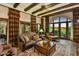 Elegant living room with beamed ceilings, a large window, and custom draperies overlooking a garden at 7710 E Golden Eagle Cir, Gold Canyon, AZ 85118