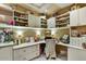 Organized home office with built-in shelving, multiple workspaces, and a bright, airy atmosphere at 7710 E Golden Eagle Cir, Gold Canyon, AZ 85118