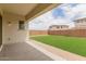 Artificial grass backyard with a covered patio at 8817 W Denton Ln, Glendale, AZ 85305