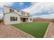 Spacious backyard features a lush green lawn and low-maintenance gravel landscaping, perfect for outdoor enjoyment at 8817 W Denton Ln, Glendale, AZ 85305