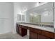 A bathroom boasts dual sinks, granite countertops, and a separate glass-enclosed shower at 8817 W Denton Ln, Glendale, AZ 85305