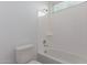 Bathroom with shower-tub combo and white tiling at 8817 W Denton Ln, Glendale, AZ 85305