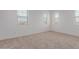 The bedroom is bright with three windows and neutral carpet at 8817 W Denton Ln, Glendale, AZ 85305