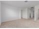 Spacious bedroom with neutral carpet and a doorway leading to other rooms at 8817 W Denton Ln, Glendale, AZ 85305