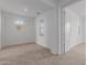 A bright bedroom features neutral carpet and multiple windows at 8817 W Denton Ln, Glendale, AZ 85305