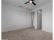 A spacious bedroom with neutral carpet and a ceiling fan at 8817 W Denton Ln, Glendale, AZ 85305