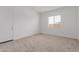 Cozy bedroom featuring neutral carpet, a window, and ample natural light at 8817 W Denton Ln, Glendale, AZ 85305