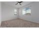 A large bedroom with neutral carpet and plenty of natural light from the windows at 8817 W Denton Ln, Glendale, AZ 85305
