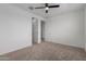 Neutral bedroom with a ceiling fan and two closets with white doors at 8817 W Denton Ln, Glendale, AZ 85305