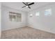 Bedroom featuring carpet and a ceiling fan in neutral tones at 8817 W Denton Ln, Glendale, AZ 85305