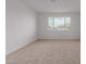 An empty bedroom boasts a window and neutral carpet at 8817 W Denton Ln, Glendale, AZ 85305