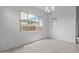 Dining room with large window offering natural light and neighborhood view at 8817 W Denton Ln, Glendale, AZ 85305