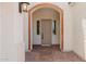 Inviting entryway with a brick-lined archway and elegant front door at 8817 W Denton Ln, Glendale, AZ 85305