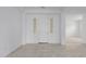 Bright entryway with light tile flooring, white walls, and an elegant front door at 8817 W Denton Ln, Glendale, AZ 85305