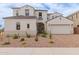 Charming two-story home with a well-manicured front yard and a two-car garage at 8817 W Denton Ln, Glendale, AZ 85305
