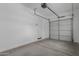 Garage with large door and white walls at 8817 W Denton Ln, Glendale, AZ 85305