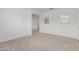 Bright living room featuring plush carpet, a large window, and neutral-toned walls at 8817 W Denton Ln, Glendale, AZ 85305
