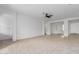Spacious living room with neutral carpet and a ceiling fan, perfect for relaxation at 8817 W Denton Ln, Glendale, AZ 85305