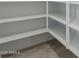 Walk-in pantry with open shelving, offering ample storage space at 8817 W Denton Ln, Glendale, AZ 85305