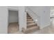 Staircase featuring carpeted steps, a closet, and a white banister at 8817 W Denton Ln, Glendale, AZ 85305