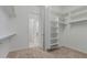 A walk-in closet with built-in shelves and clothing rods for optimal storage at 8817 W Denton Ln, Glendale, AZ 85305