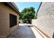 Backyard with stone tile, mature trees, and block wall fencing at 9419 E Riviera Dr, Scottsdale, AZ 85260