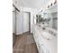 Bright bathroom with double sinks, granite countertops, and large framed mirror at 9419 E Riviera Dr, Scottsdale, AZ 85260