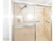 Bathroom featuring neutral tile shower with glass sliding doors and chrome hardware at 9419 E Riviera Dr, Scottsdale, AZ 85260