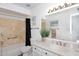 Bright bathroom featuring a combination shower and bathtub with a marble tile backsplash at 9419 E Riviera Dr, Scottsdale, AZ 85260