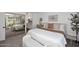 Bright bedroom featuring neutral decor, comfortable king bed, and a private en-suite bathroom at 9419 E Riviera Dr, Scottsdale, AZ 85260