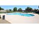 Community pool with seating, shade, and stairs at 9419 E Riviera Dr, Scottsdale, AZ 85260