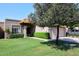 Charming home with a well-maintained lawn, lush green shrubs, and an attached two-car garage at 9419 E Riviera Dr, Scottsdale, AZ 85260