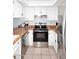 Well-lit kitchen with white cabinets, butcher block countertops, and stainless steel appliances at 9419 E Riviera Dr, Scottsdale, AZ 85260