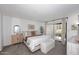 Bright main bedroom with a sliding glass door, neutral decor, and a comfortable king-size bed at 9419 E Riviera Dr, Scottsdale, AZ 85260