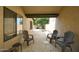 Covered patio area with four chairs, and stone flooring at 9419 E Riviera Dr, Scottsdale, AZ 85260