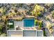 An aerial view of a backyard oasis including a pool, spa, outdoor kitchen, and lounge area surrounded by desert vegetation at 9894 E Miramonte Dr, Scottsdale, AZ 85262